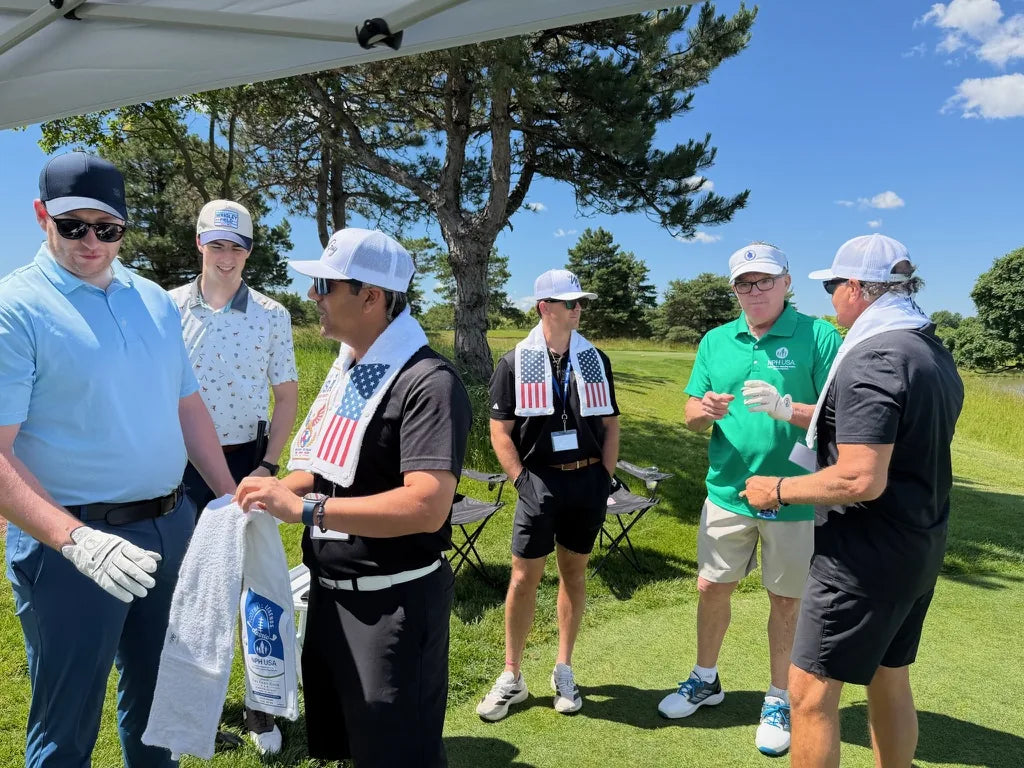 Golfers at the tent trying on LivWizeGuy towels