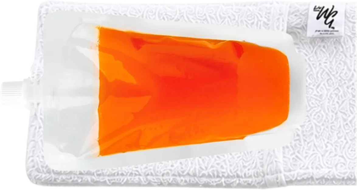 A drink pouch laid on the left end of the towel, with its spout lined up with the end
