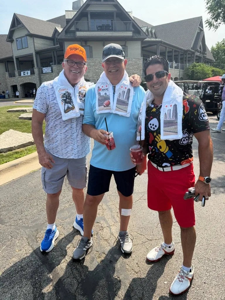 Three golfers outside the clubhouse wearing LivWizeGuy towels