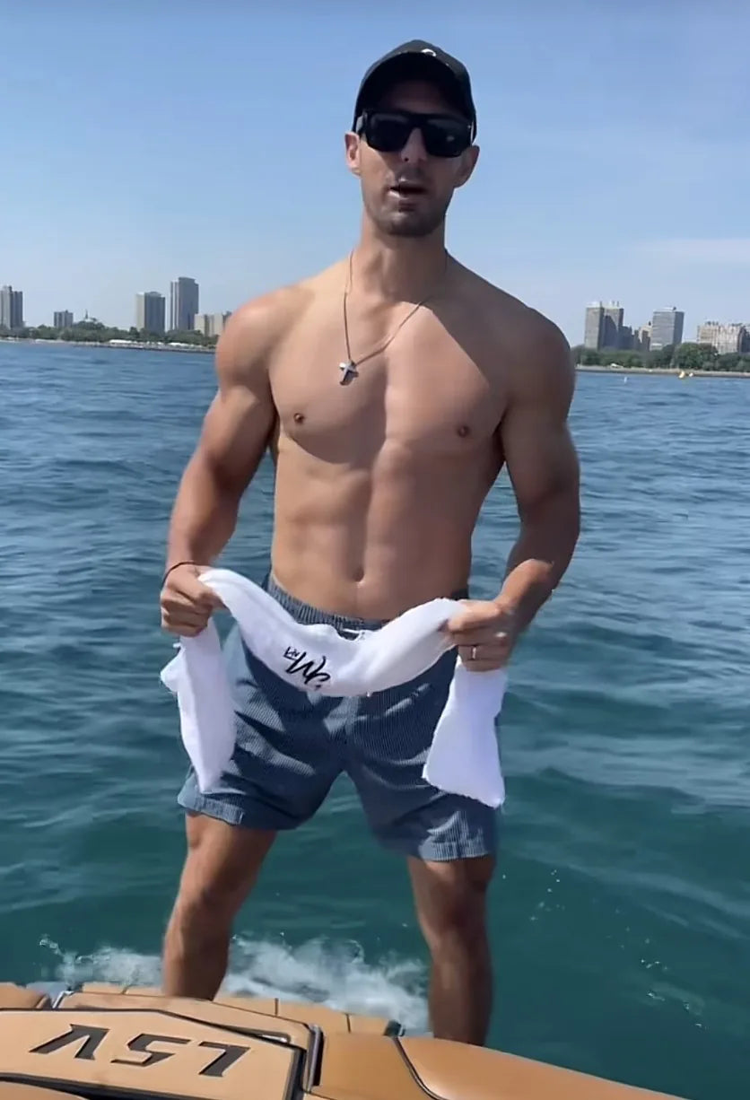 Man on a boat holding a LivWizeGuy towel